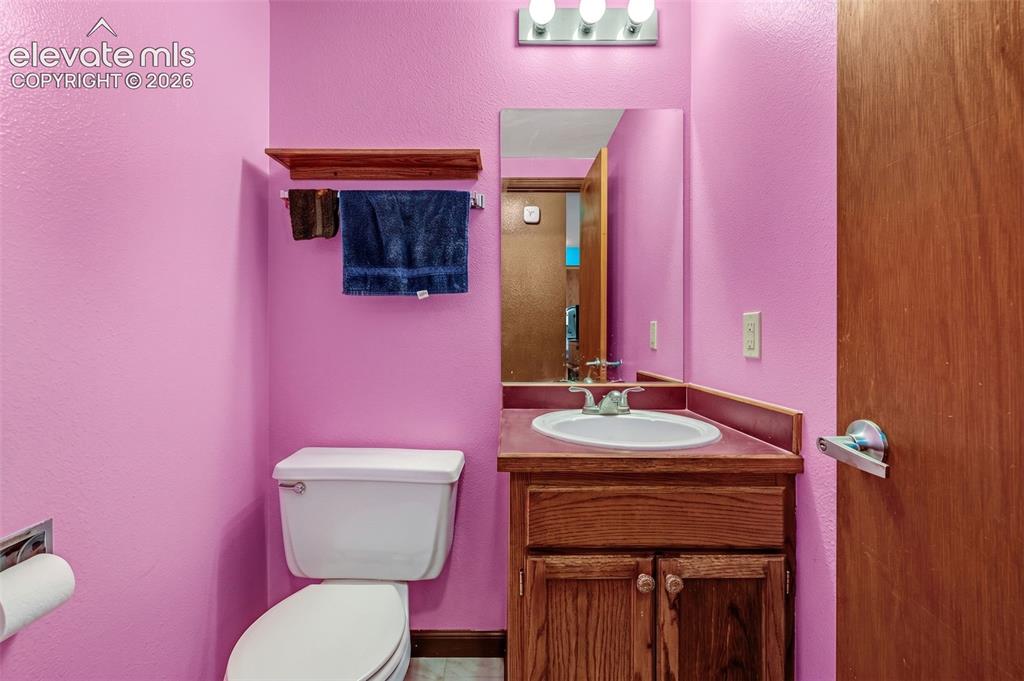 613 Wheat Field Road Fountain, CO 80817 - Photo 6 of 32 a bathroom with a sink a toilet and mirror