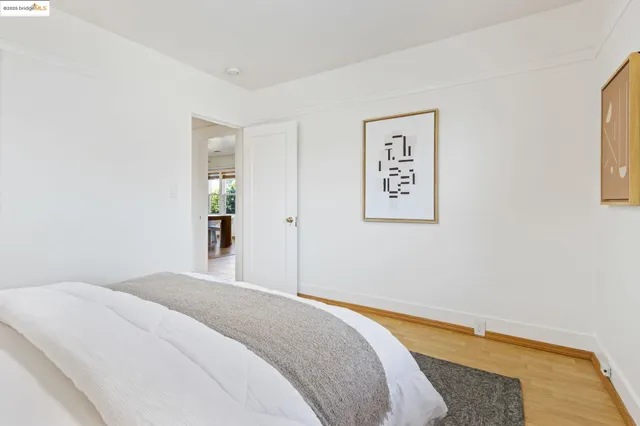 a bedroom with a bed and a painting on the wall