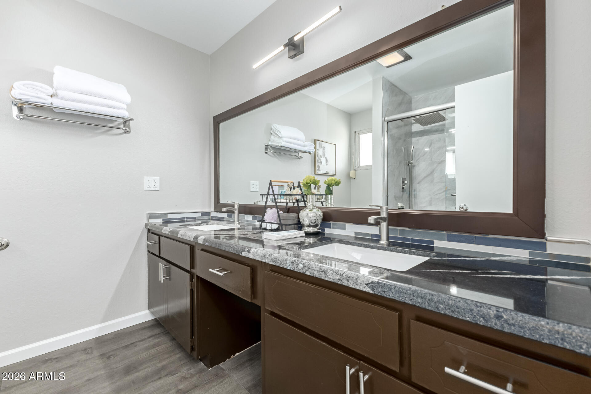 2915 West Hearn Road Phoenix, AZ 85053 - Photo 14 of 28 a bathroom with a granite countertop sink a large mirror and a window