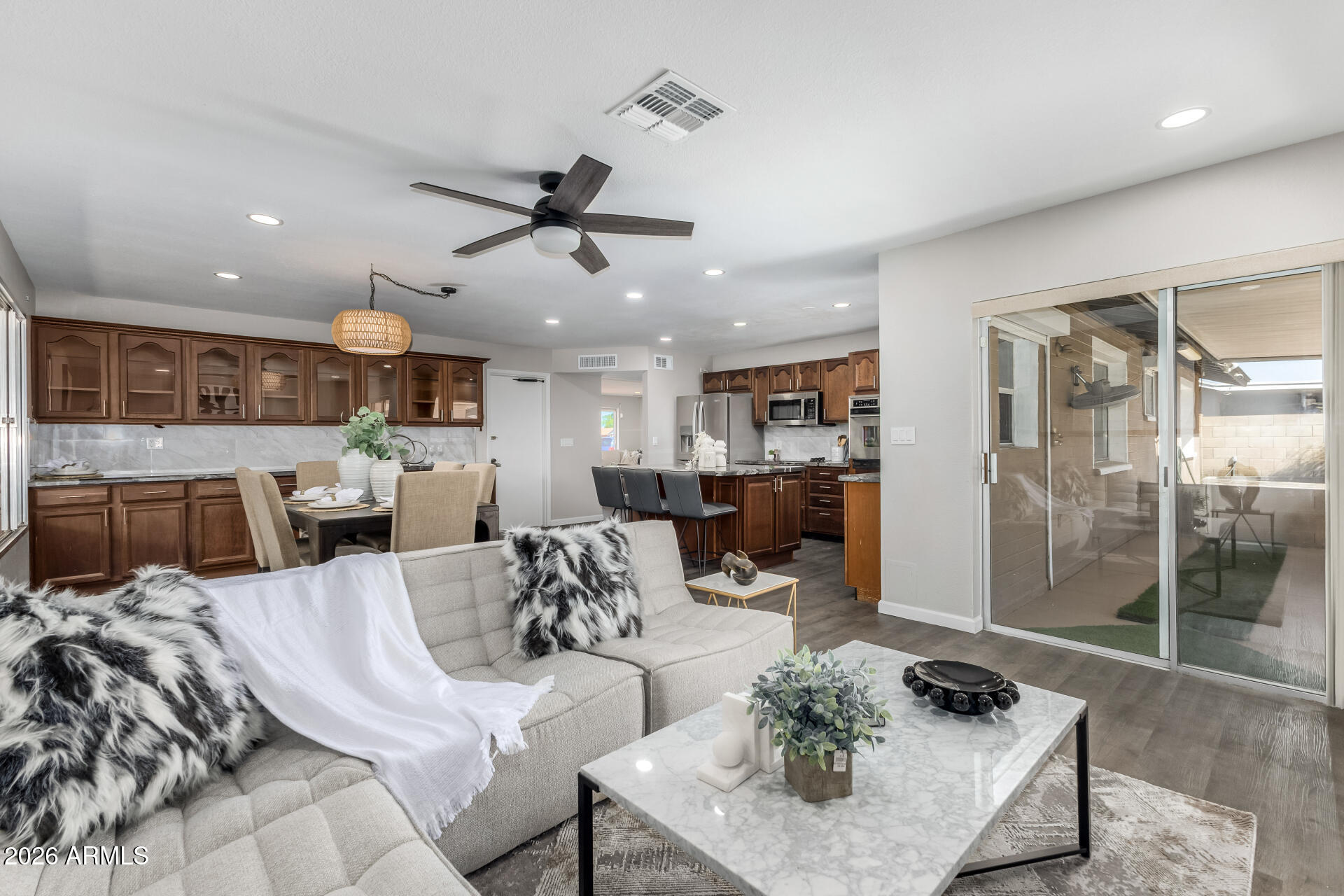 2915 West Hearn Road Phoenix, AZ 85053 - Photo 4 of 28 a living room with furniture kitchen view and a chandelier
