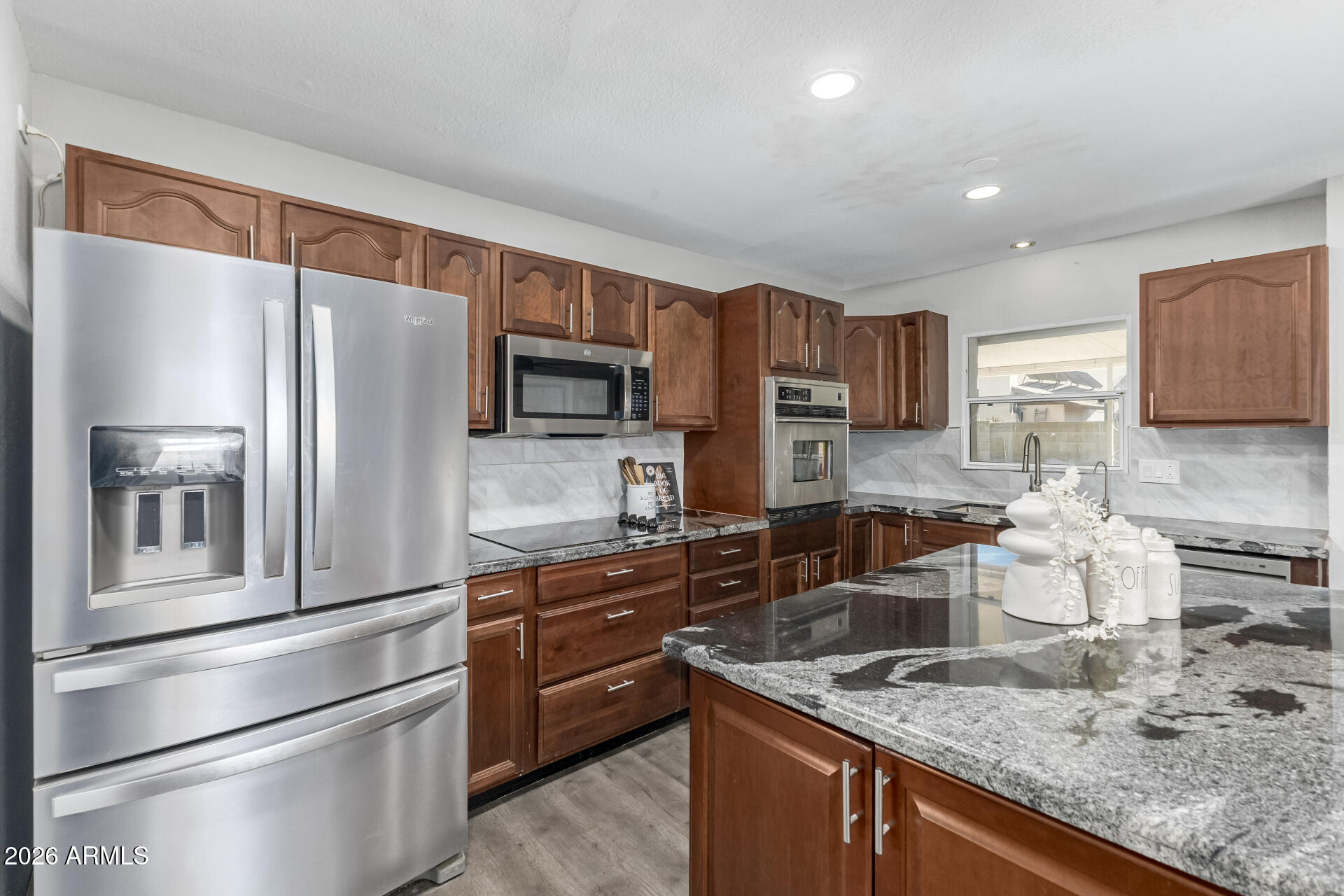 2915 West Hearn Road Phoenix, AZ 85053 - Photo 8 of 28 a kitchen with stainless steel appliances granite countertop a refrigerator stove and sink