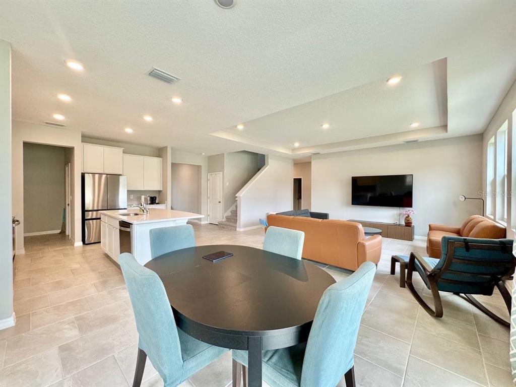 7724 Broad River Avenue Land O Lakes, FL 34638 - Photo 13 of 40 a living room with stainless steel appliances furniture and a flat screen tv