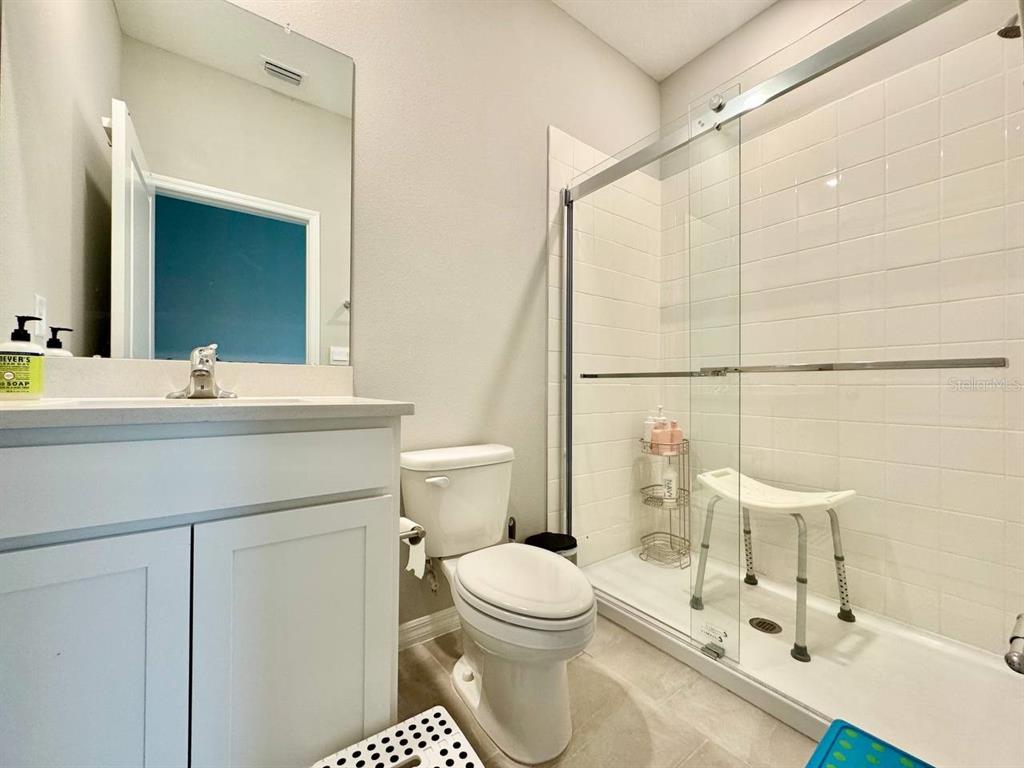 7724 Broad River Avenue Land O Lakes, FL 34638 - Photo 15 of 40 a bathroom with a sink toilet a mirror and shower