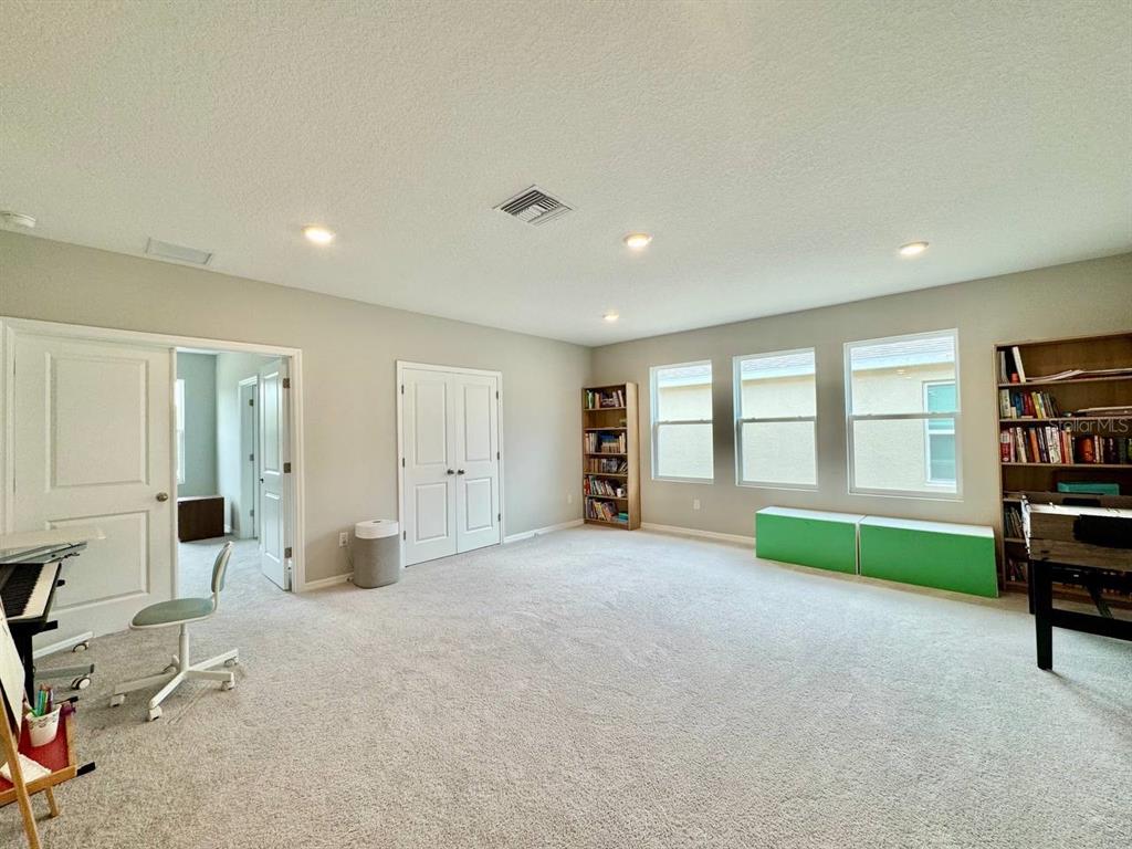 7724 Broad River Avenue Land O Lakes, FL 34638 - Photo 16 of 40 a view of an empty room with window and cabinet