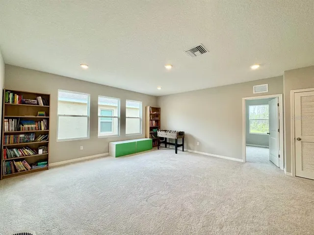 a view of a livingroom with a bookshelf and a window