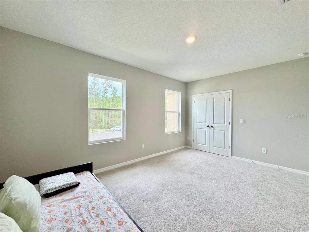 7724 Broad River Avenue Land O Lakes, FL 34638 - Photo 20 of 40 a bedroom with a bed and a window