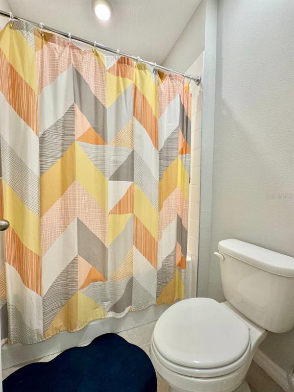 7724 Broad River Avenue Land O Lakes, FL 34638 - Photo 23 of 40 a white toilet sitting next to a bathroom