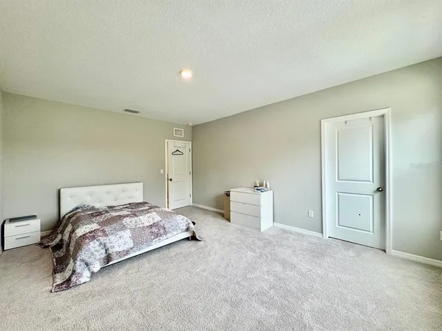 a bedroom with a bed and a cabinets