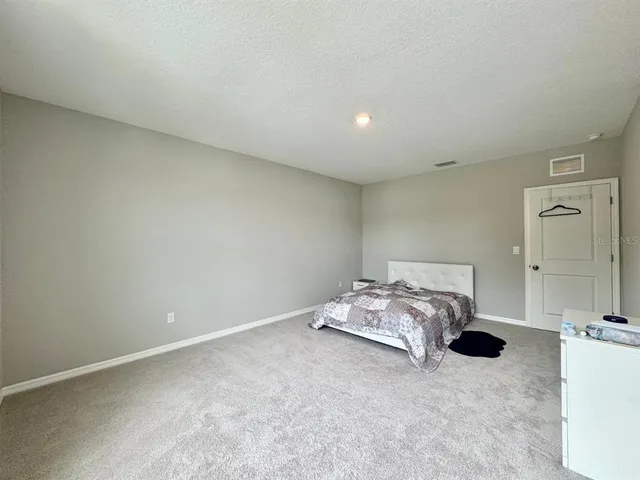 a bedroom with a bed and a cabinets
