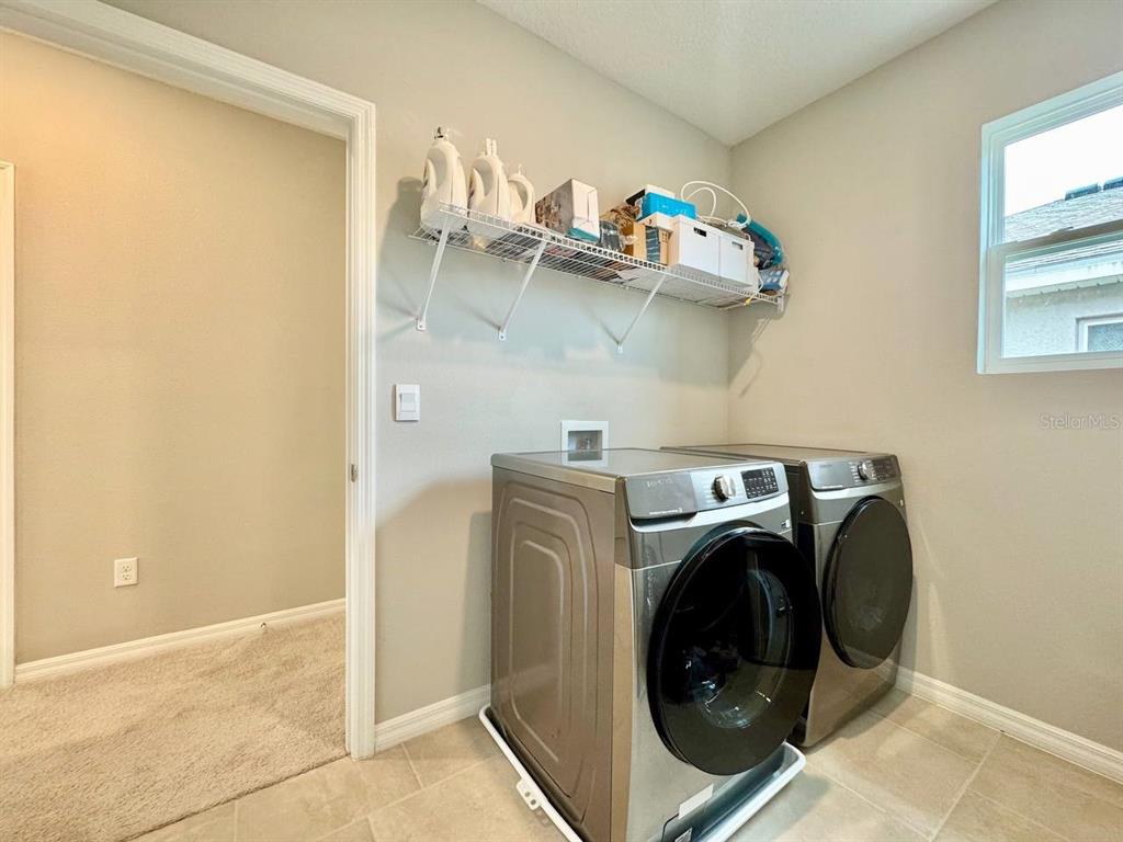 7724 Broad River Avenue Land O Lakes, FL 34638 - Photo 27 of 40 a utility room with dryer and washer