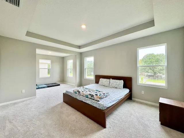 a bedroom with a bed and window