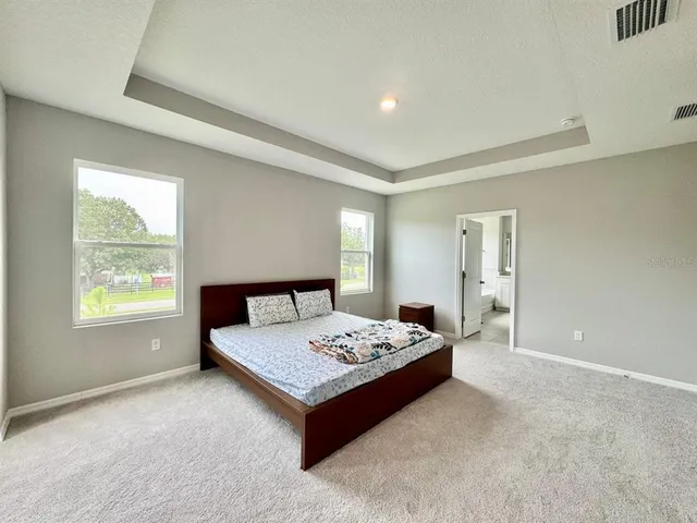 a living room with a bed furniture and a window