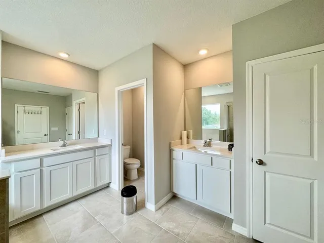 a bathroom with a double vanity sink and mirror