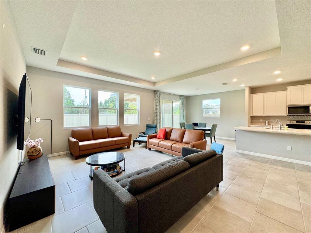7724 Broad River Avenue Land O Lakes, FL 34638 - Photo 4 of 40 a living room with furniture and a flat screen tv