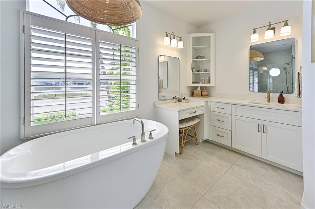 271 Bayview Avenue Naples, FL 34108 - Photo 20 of 35 a spacious bathroom with a tub sink and mirror