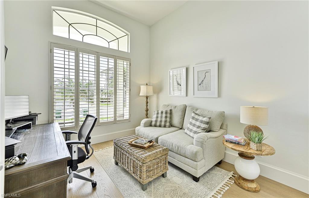 271 Bayview Avenue Naples, FL 34108 - Photo 21 of 35 a living room with furniture a flat screen tv and a window