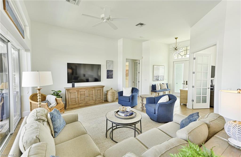 271 Bayview Avenue Naples, FL 34108 - Photo 6 of 35 a living room with furniture and a flat screen tv
