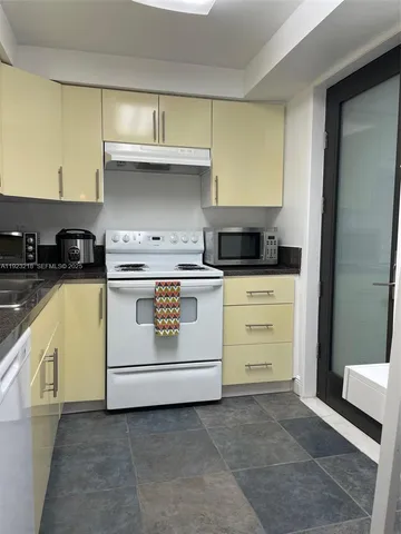 a kitchen with cabinets appliances and a sink