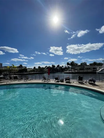 a view of a swimming pool and an outdoor seating
