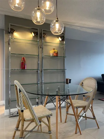 a view of a dining room with furniture and a chandelier