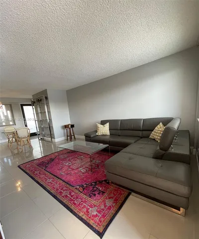 a living room with furniture and a rug
