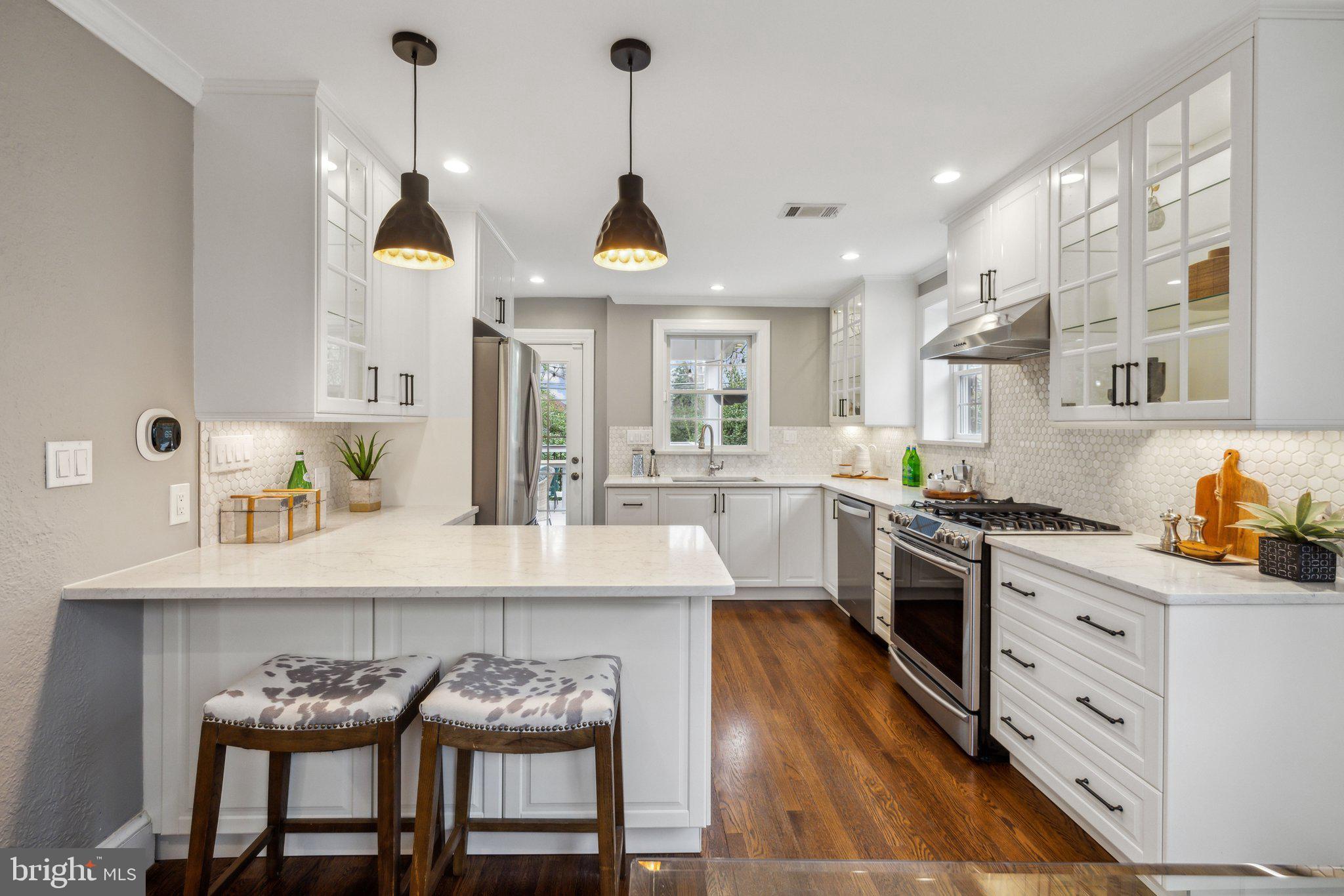3808 North Pershing Drive Arlington, VA 22203 - Photo 14 of 42 a kitchen with stainless steel appliances granite countertop a sink a stove and chairs