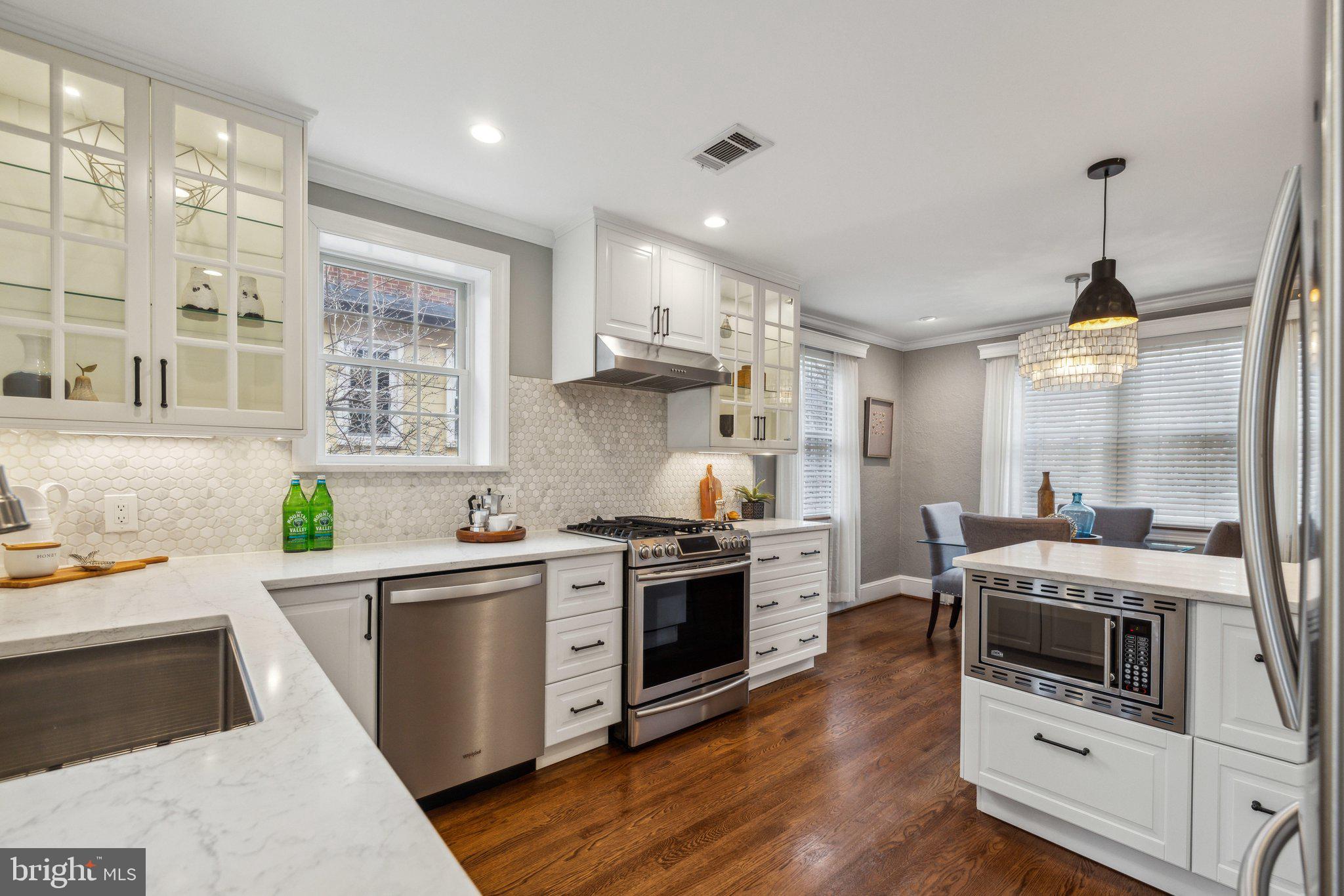 3808 North Pershing Drive Arlington, VA 22203 - Photo 16 of 42 a kitchen with a stove a sink a refrigerator and wooden floor