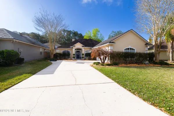 a front view of house with yard and green space