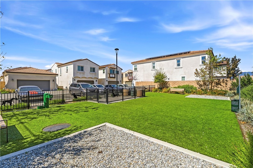 335 Carson Court Rialto, CA 92376 - Photo 27 of 34 a view of a big house with a big yard and large trees