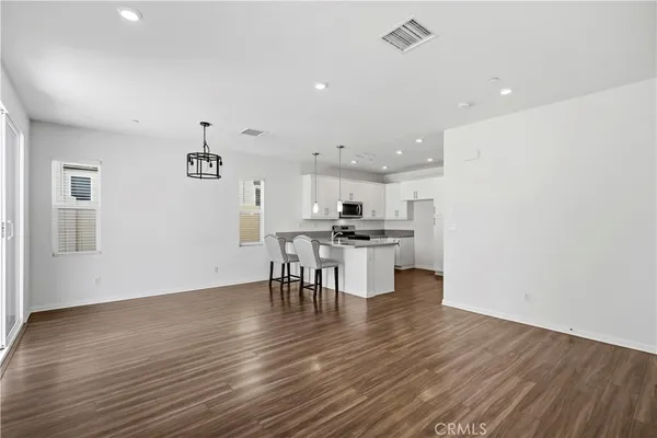 a view of kitchen with cabinets and wooden floor
