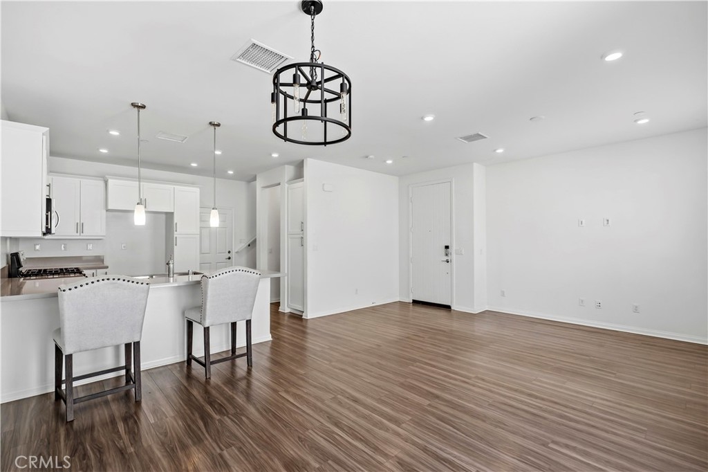 335 Carson Court Rialto, CA 92376 - Photo 4 of 34 a view of dining room kitchen with stainless steel appliances wooden floor dining table and chairs