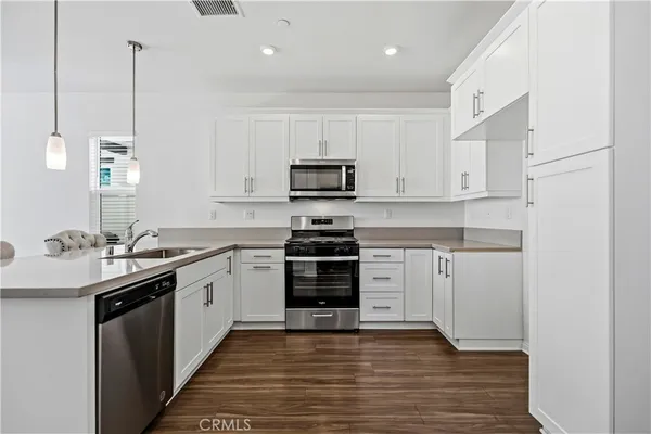 a kitchen with granite countertop a stove and a sink