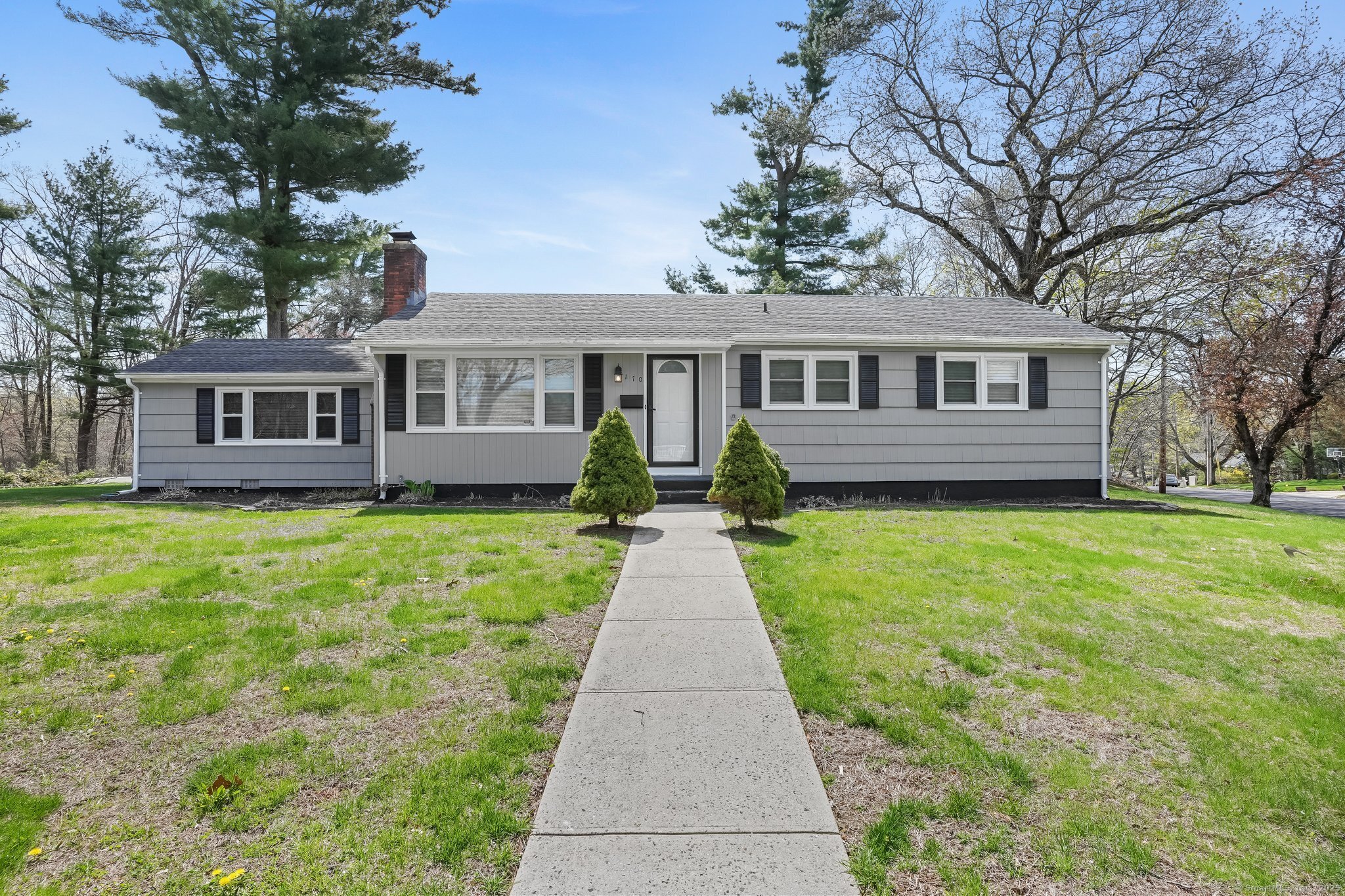 a front view of a house with a garden