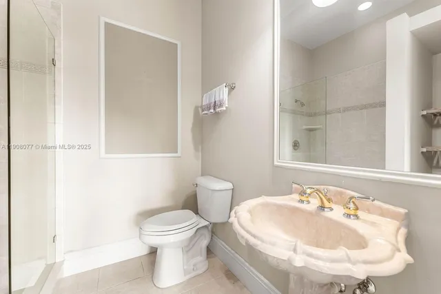 a bathroom with a sink and mirror with toilet