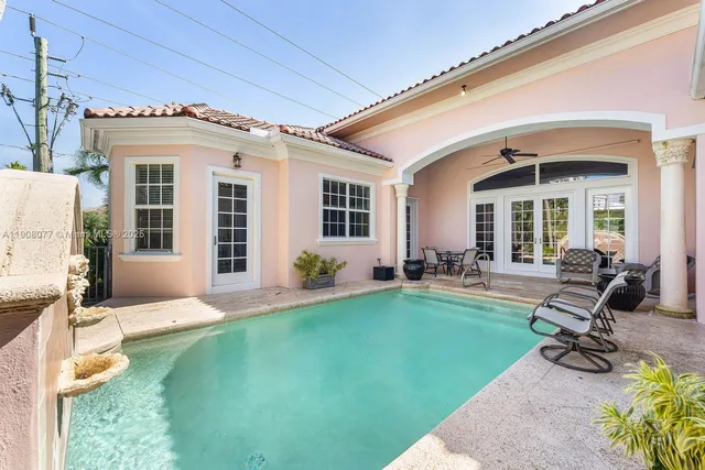 a view of a house with backyard porch and sitting area
