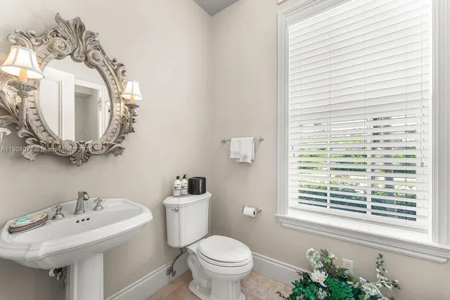 a bathroom with a toilet sink and mirror