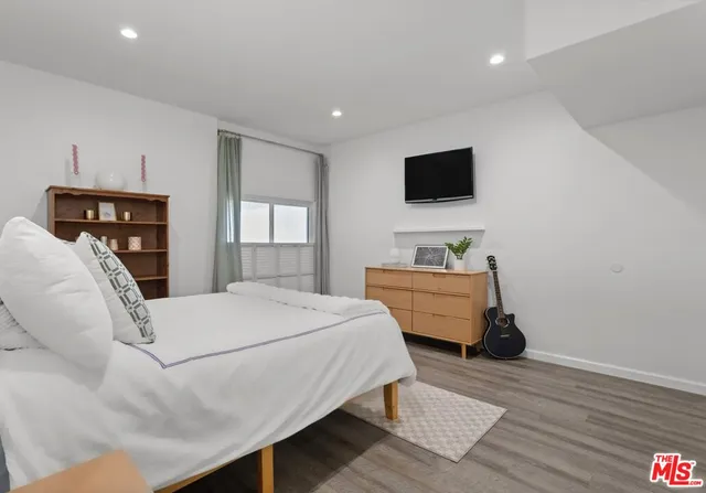 a room with a bed and a television