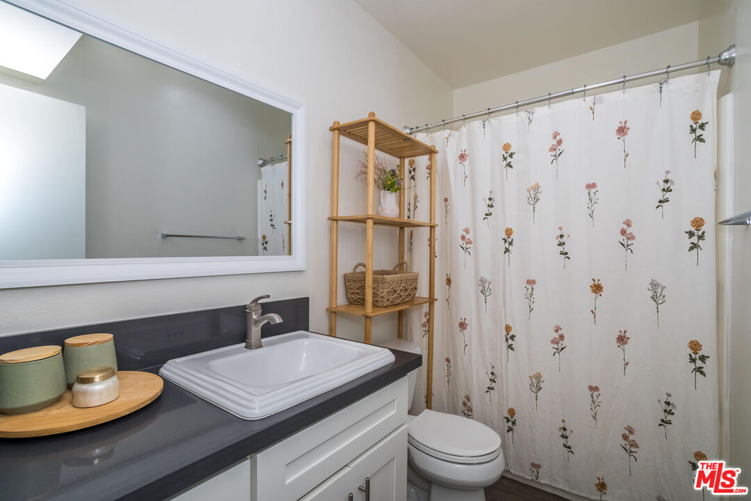 5414 Newcastle Avenue, Unit 50 Encino, CA 91316 - Photo 14 of 23 a bathroom with a sink toilet and shower