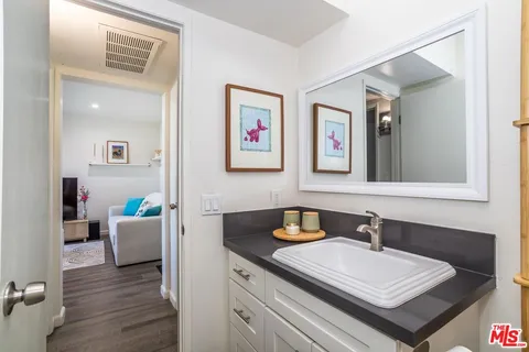 a bathroom with a sink a mirror and a window