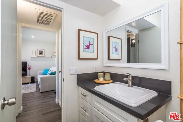 a bathroom with a sink a mirror and a window