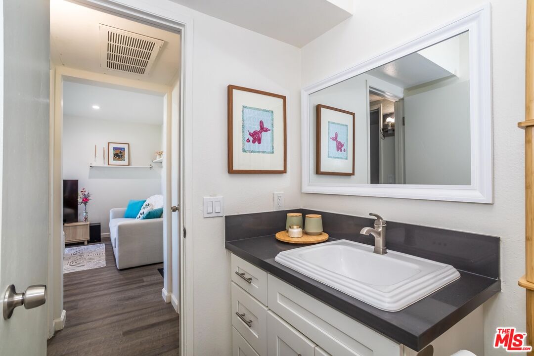 5414 Newcastle Avenue, Unit 50 Encino, CA 91316 - Photo 15 of 23 a bathroom with a sink a mirror and a window