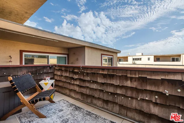 a backyard of a house with barbeque oven and outdoor seating