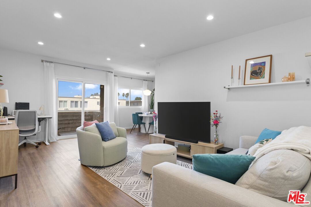 5414 Newcastle Avenue, Unit 50 Encino, CA 91316 - Photo 2 of 23 a living room with furniture and a flat screen tv