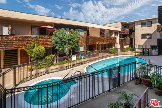 a balcony with tall trees in front of it