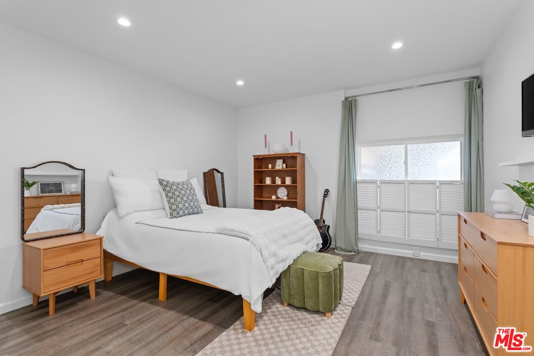 5414 Newcastle Avenue, Unit 50 Encino, CA 91316 - Photo 10 of 23 a bedroom with a bed and wooden floor