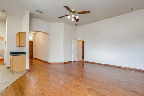 a view of an empty room with a kitchen