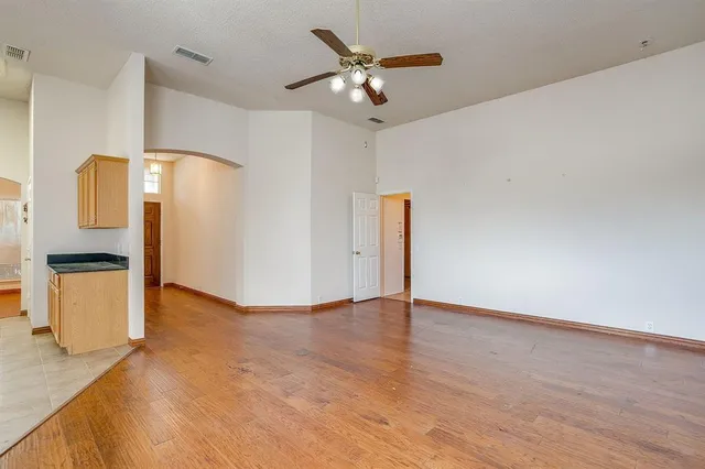 a view of an empty room with a kitchen