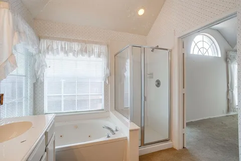 a bathroom with a bathtub and a shower