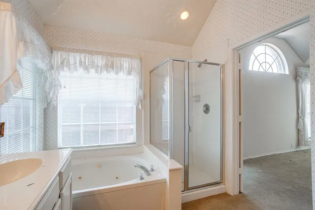 a bathroom with a bathtub and a shower