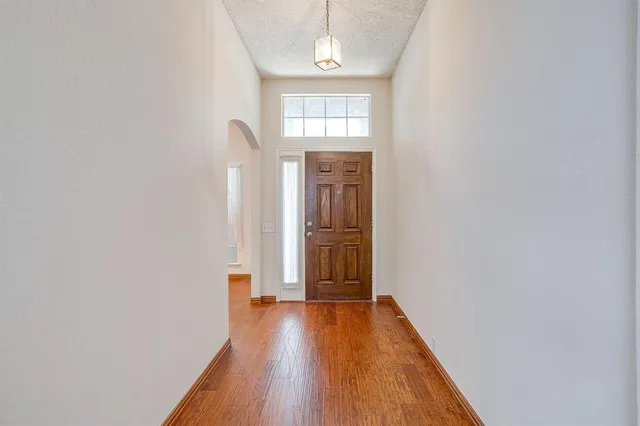 a view of hallway with wooden floor